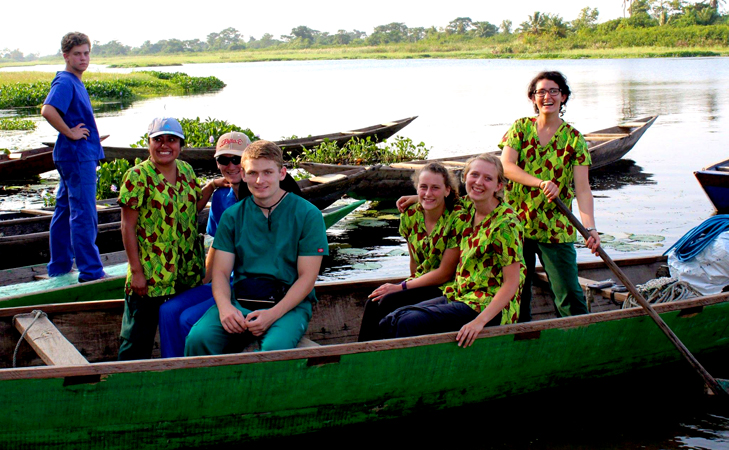 This summer's five Ghana interns and other team members try out a local canoe.