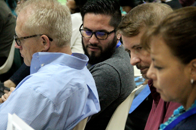 Reach Beyond President Steve Harling (left), Lee Perry and his wife, Paulina, listen as Bryan Rubio interprets a sermon by Carlos Scott.