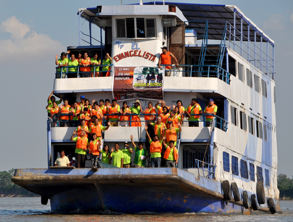 Participants and crew members on the flat-bottomed riverboat, El Evangelista.