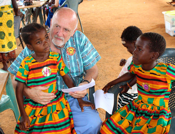 Dr. Steve Nelson talks with young patients in colorful uniforms..