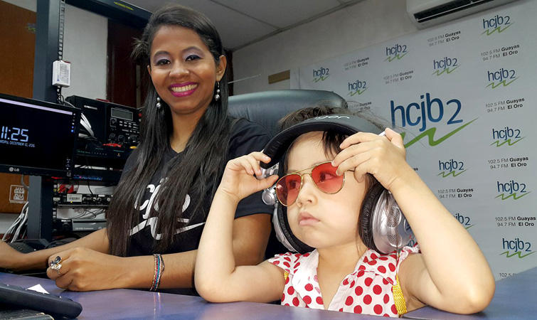 Little Valentina Morante, alongside Mayra Plaza, takes part in live programming during the open house at HCJB2 in Guayaquil.