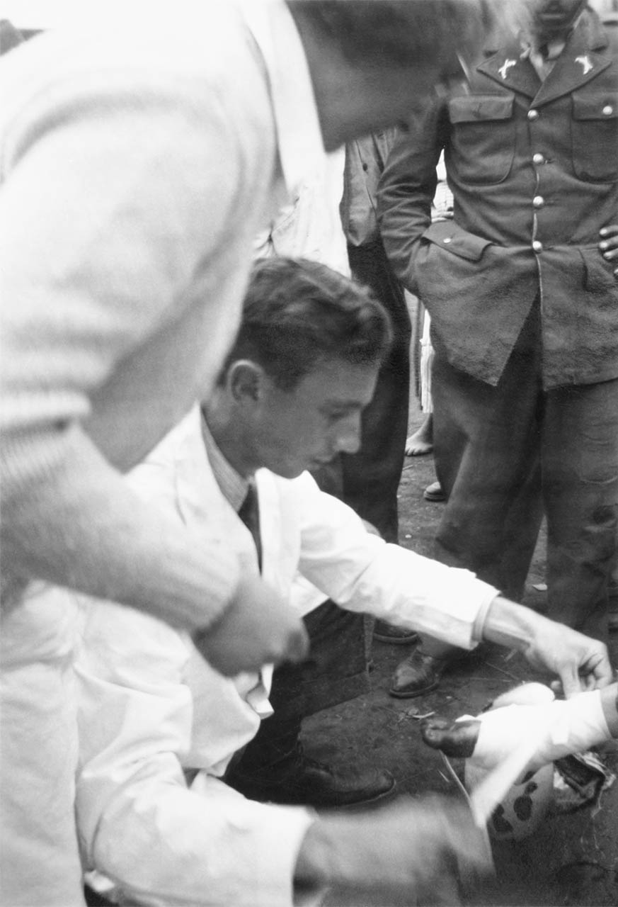 Dr. Paul Roberts bandages a foot in the aftermath of the 1949 Ambato earthquake in Ecuador.