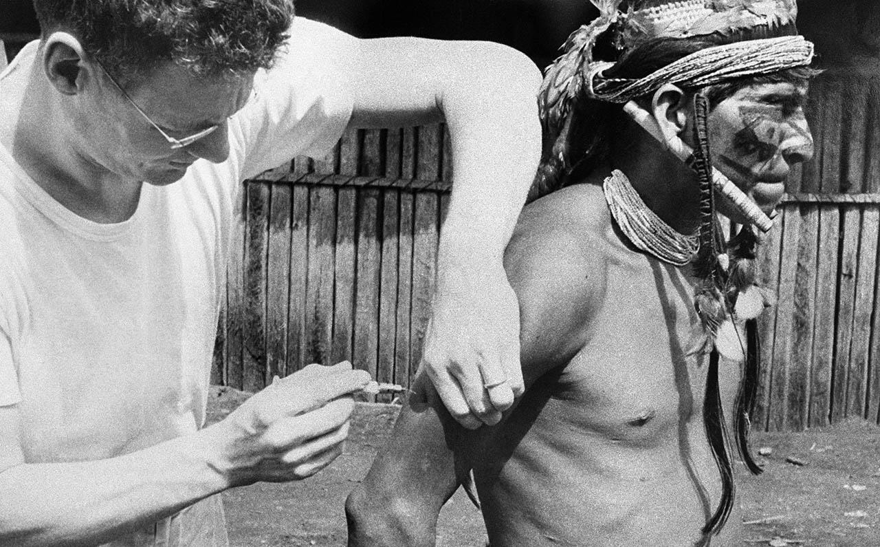 Dr. Ev Fuller attempts to vaccinate chief Tsantiacu (note the bending needle). Tsantiacu was from the Achuar tribe known for shrinking heads. Tsantiacu became a follower of Jesus.