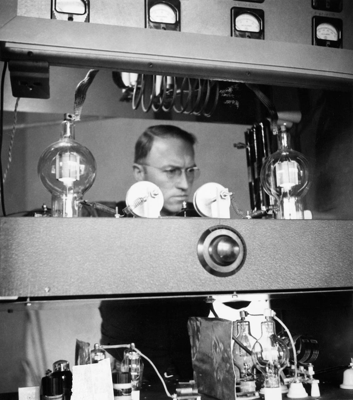 Clarence Moore checks Radio Station HCJB's 10,000 Watt transmitter that he designed and built.