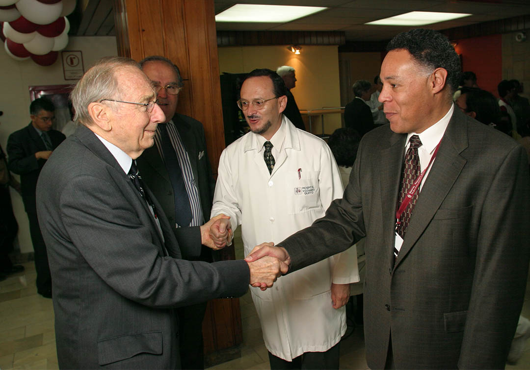 Dr. Paul Roberts is warmly greeted by Ecuadorian doctors at Hospital Vozandes Quito.