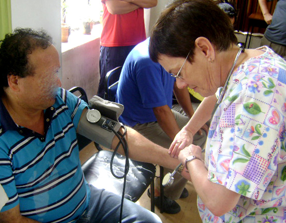 Rita Whaley checks the blood pressure of an inmate at Ex Penal García Moreno, a former penitentiary in Quito, Ecuador.