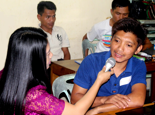 Speakers of a tribal language in Southeast Asia practice interviewing techniques during a radio training class.