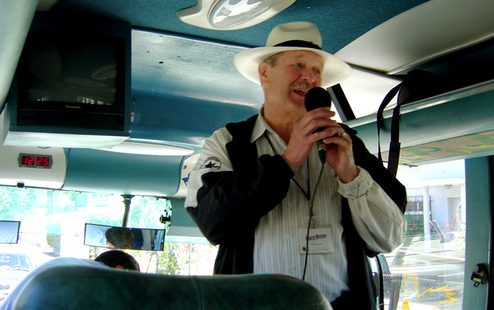 Gary Meier gives information on a tour bus in Ecuador.