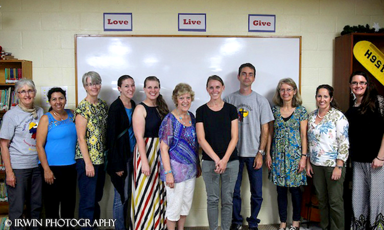 Carolyn Wolfram (third from left) along with current and former teachers at Nate Saint Memorial School: Rocio Salas, Rachel Hahn, Beth Montero, Flo Friesen, Bailey Espinoza, Randy Umble, Dorothy Nelson, Katie Williams, Jennifer Kendrick and others. (photo by Chad Irwin)