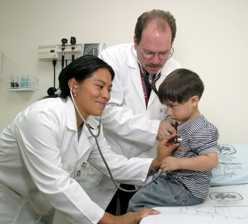 Dr. Jeff Maudlin and an intern check a young patient at Hospital Vozandes-Quito.