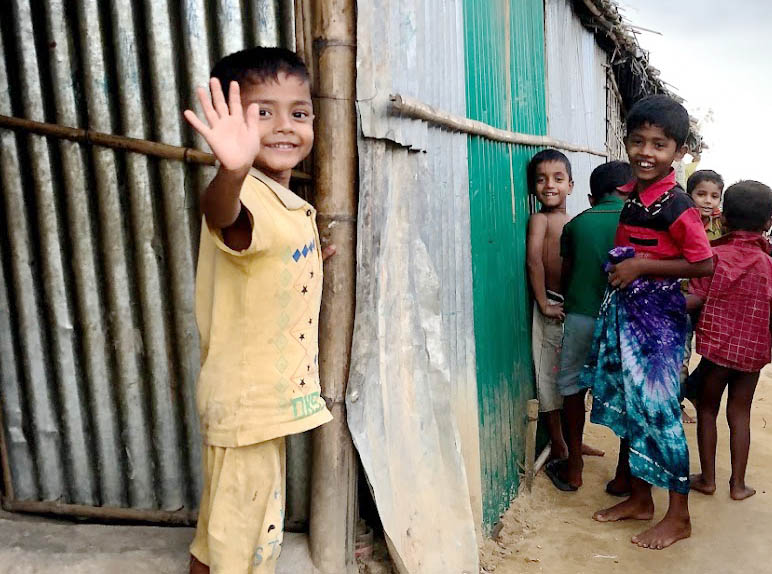 Rohingya Refugee Camp - Children Smiling on Path Between Homes
