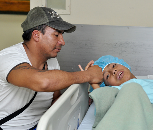 A father consoles his young son before going into surgery (archive photo).