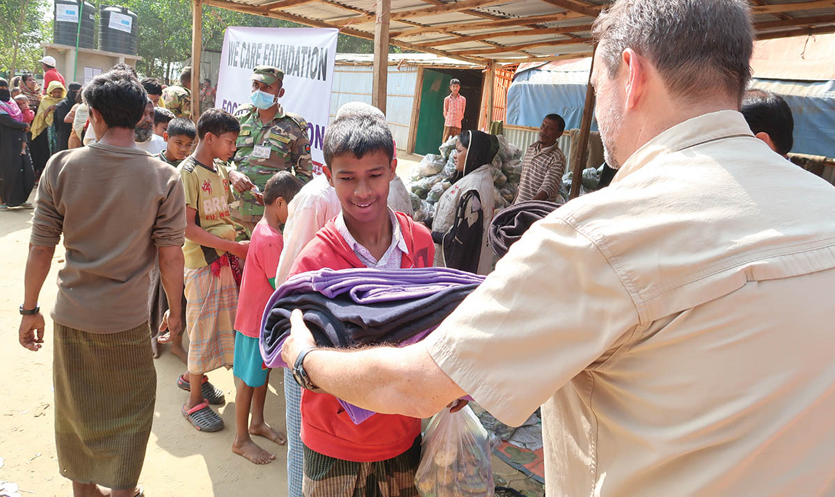 Ty distribute blankets at a Rohingya refugee camp in Bangladesh
