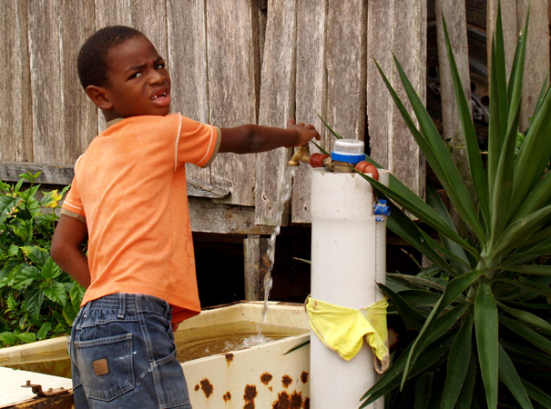 A young boy in Yalare draws water from a new tap