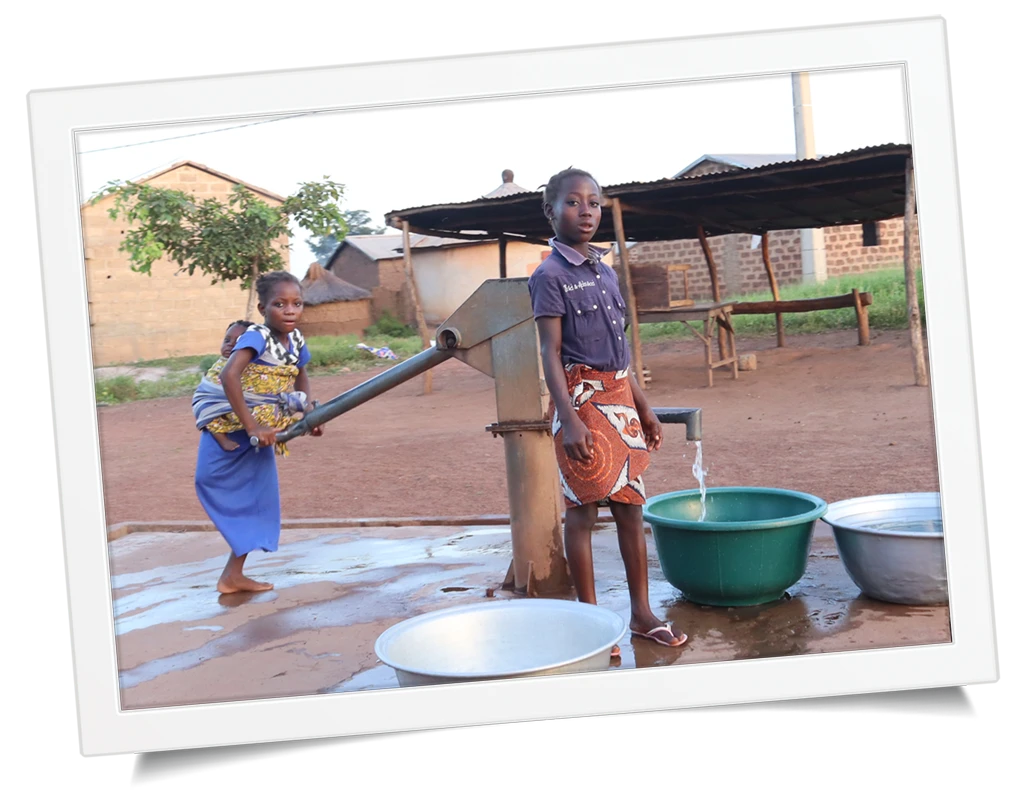 Girls getting water from a clean deep-water pump well in Sub-Saharan Africa