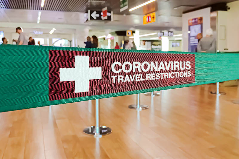Coronavirus travel restrictions sign inside an airport