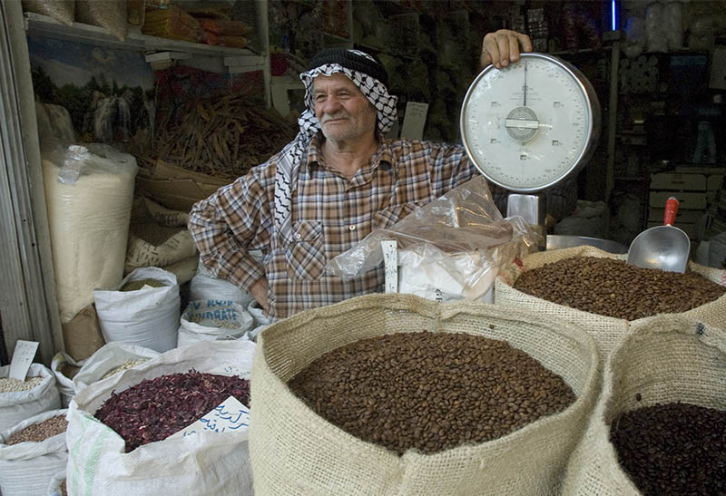 Man selling coffee in a Middle-Eastern market.