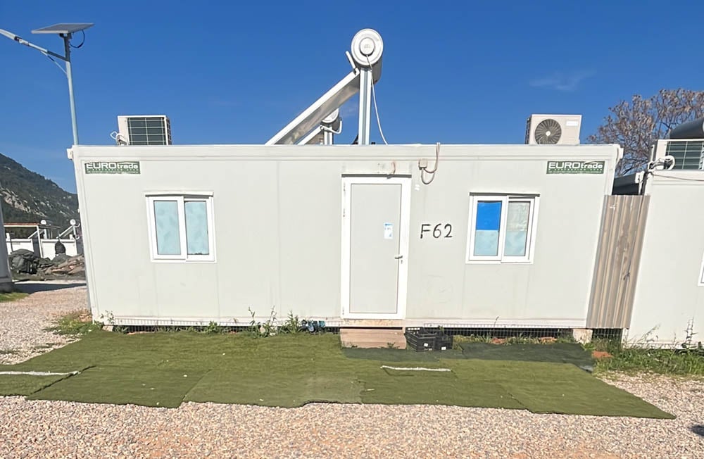 Newly placed artificial turf provides a bit of green space for ISO box homesront