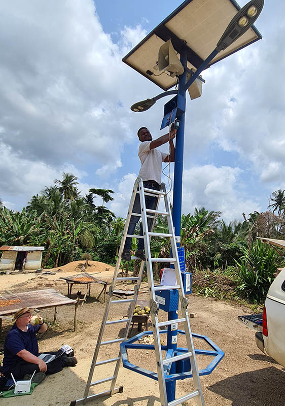 Alfred and Bob work on setting up the multipurpose-pole that is declaring the Gospel in a small village in Ghana