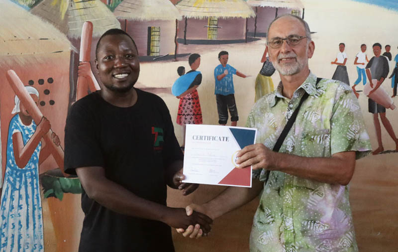 The station manager helped hand out diplomas to staff who completed Reach Beyond's training course.