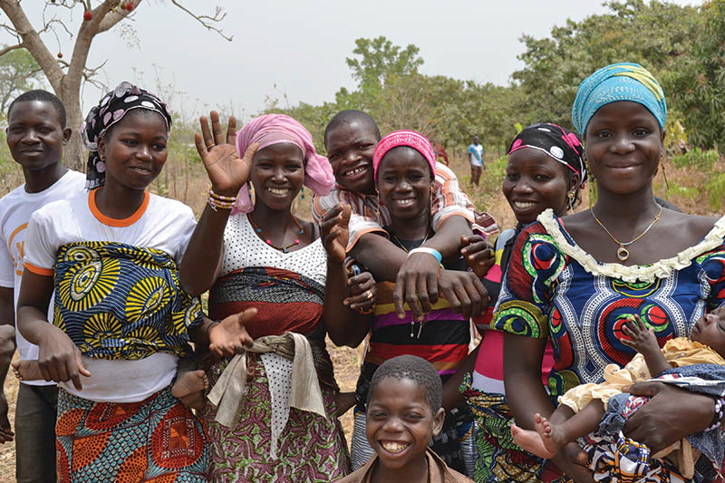 women smile at the camera in West Africa
