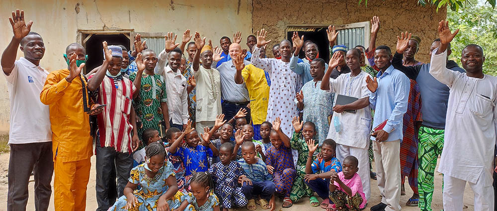 Group of smiling people outside a church in West Africa