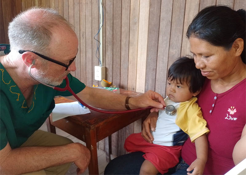 Dr. Mark Nelson examines a child during mission aboard