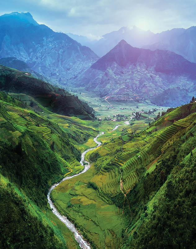 Lush fertile valley surrounded by mountains in Southeast Asia