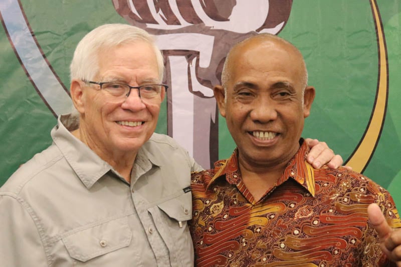 David smiles for a photo with a radio station manager at one of Reach Beyond's leadership training conferences.