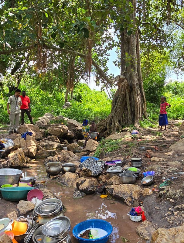 Communities without wells rely on streams or natural springs like this one that appears to come out of a sacred tree, which villagers worship and pray to.