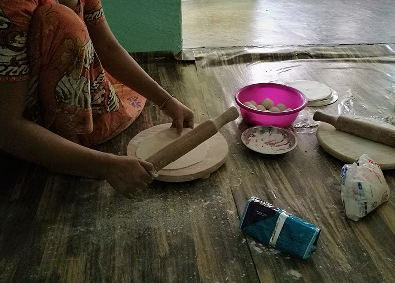 Refugee woman preparing food