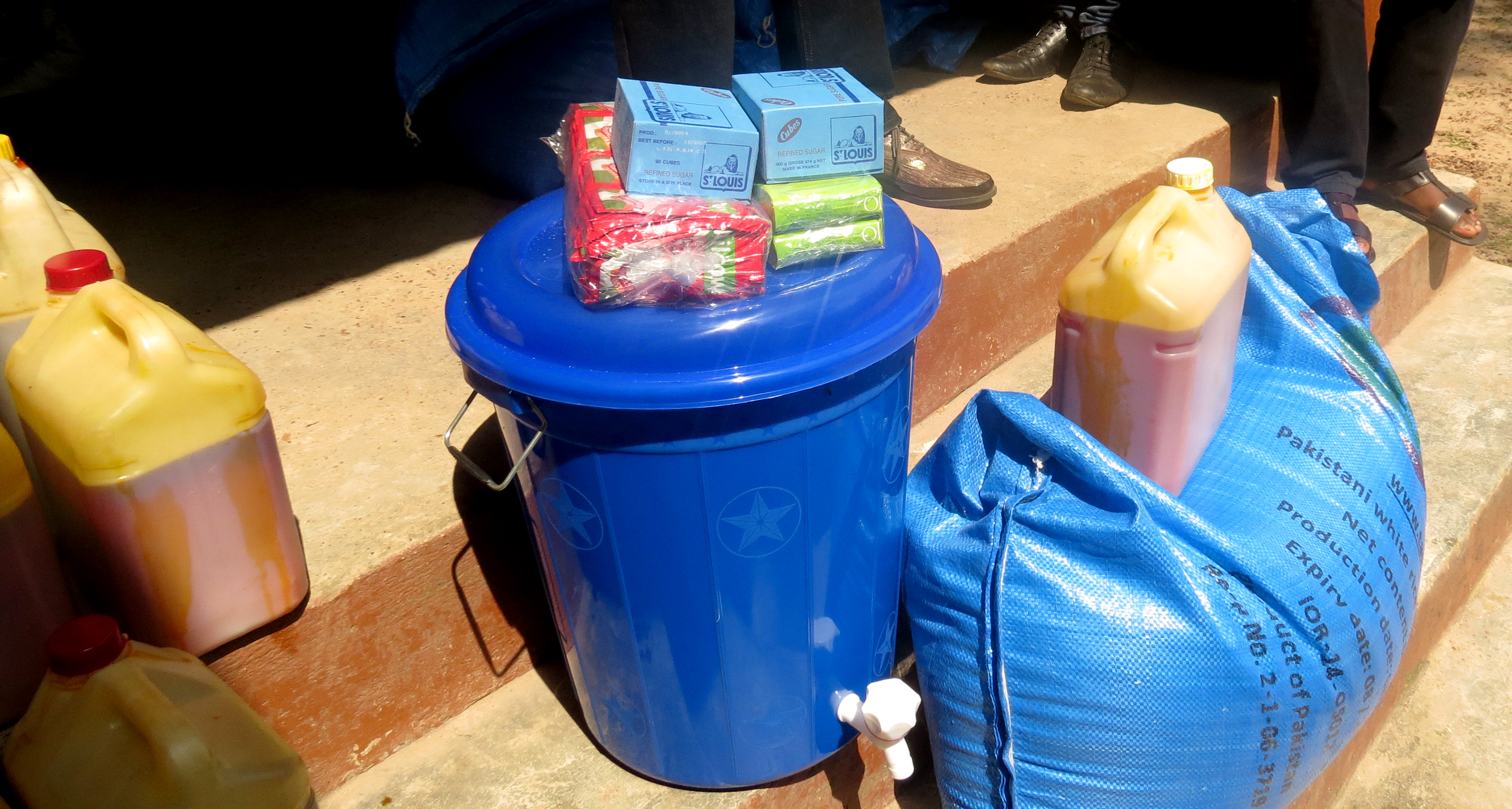 Examples of food and cleaning supplies being distributed to quarantined families.