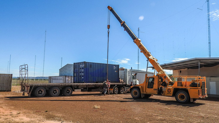 A crane is used to unload the heavy HC100 transmitter at the broadcast site in Kununurra, Australia.