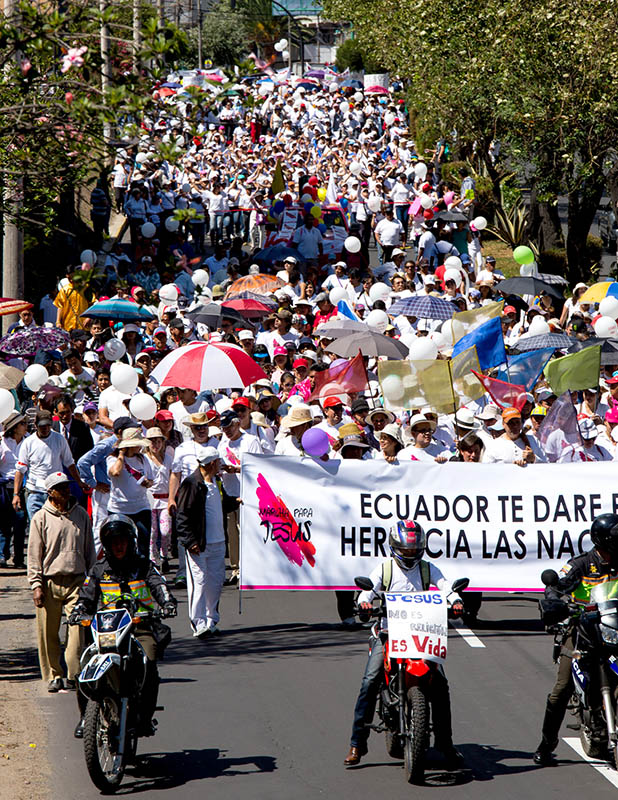 Believers march down the streets of Quito.