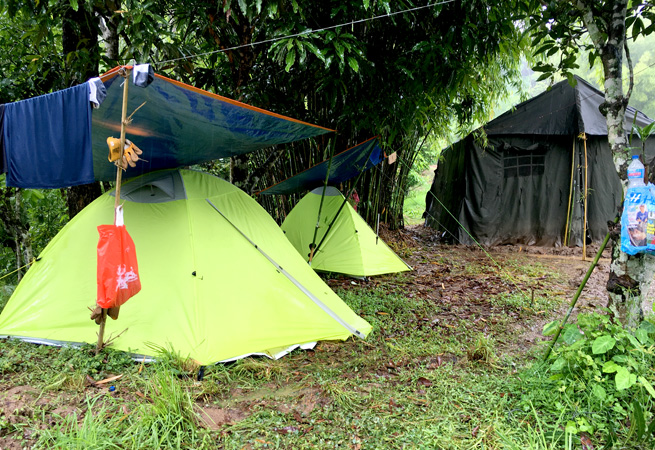 Using extra tarps to keep the tents dry during the constant rains.