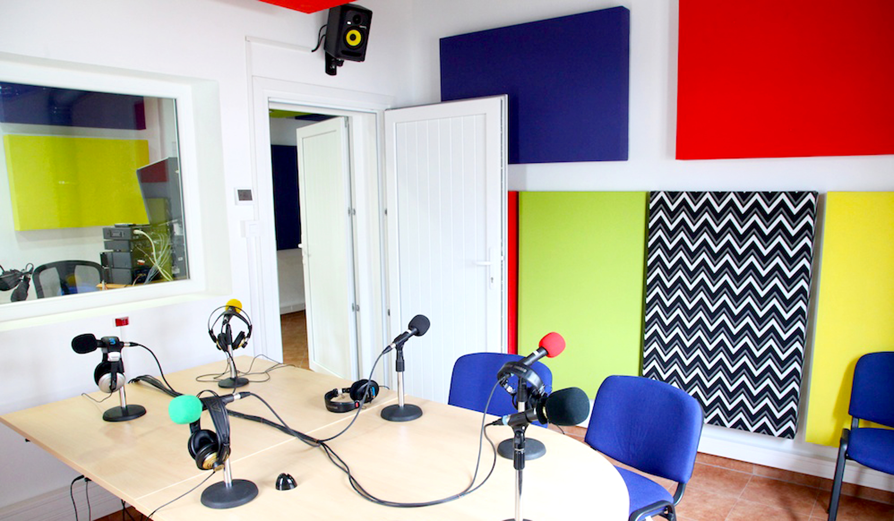 Colorful acoustical boxes mounted on the walls help balance the sound in the new studios.