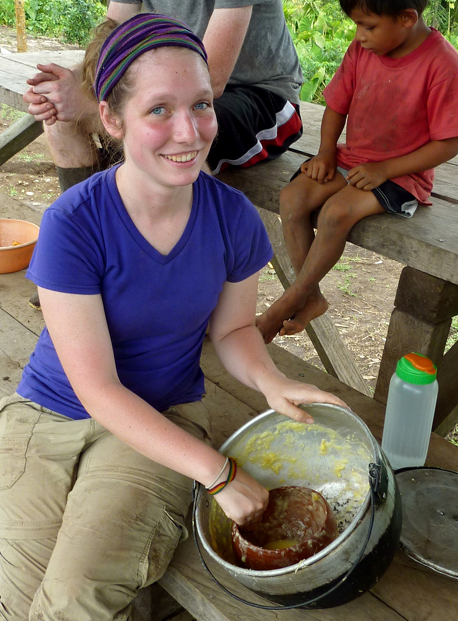 Rachel uses a bowl to serve chicha.
