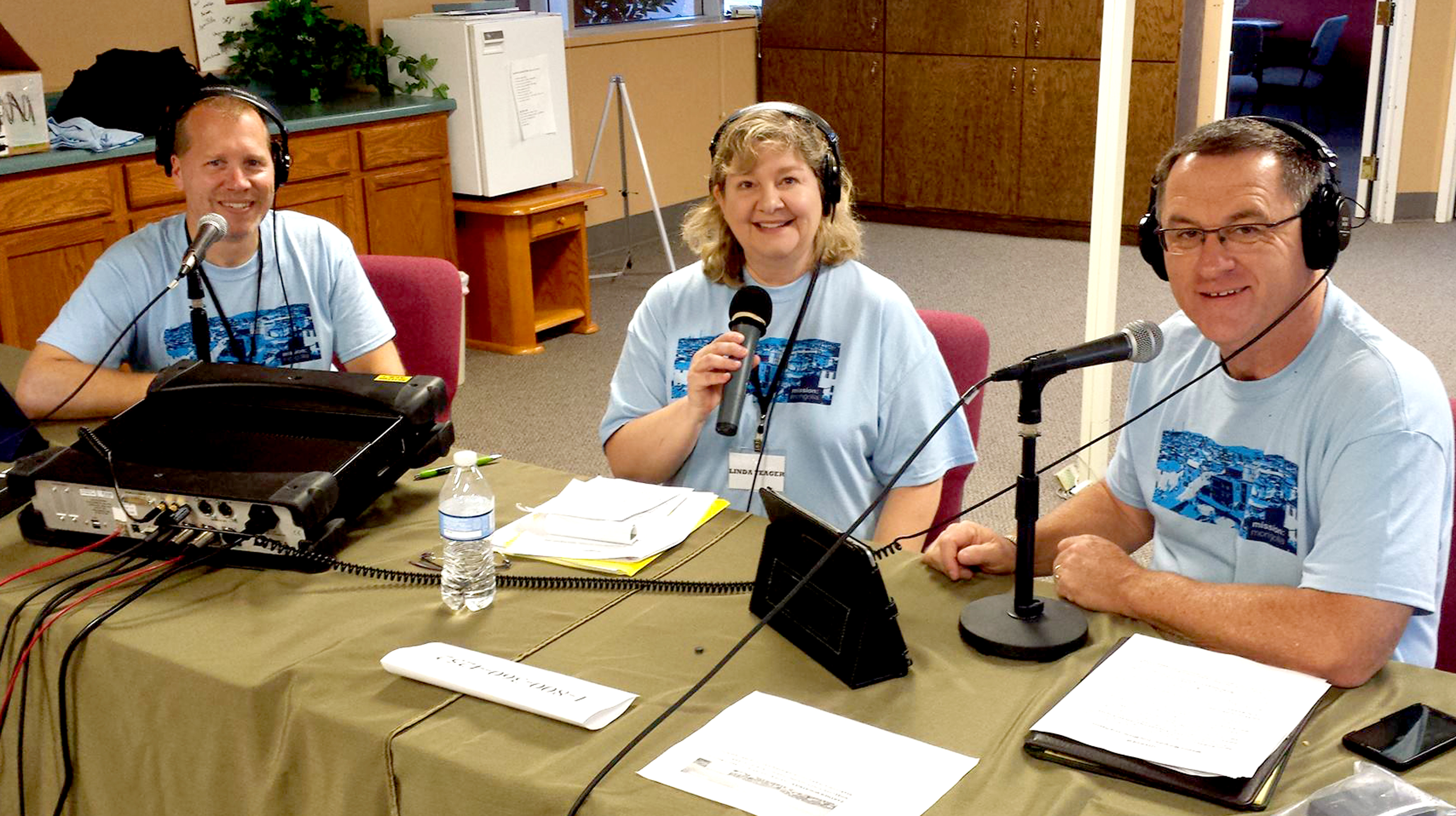Ray Hashley (left) and Linda Yeager of Moody station WGNR in Indianapolis, Ind., together with Jon Fugler do a live remote from the Reach Beyond Ministry Service Center in Colorado Springs, Colo.